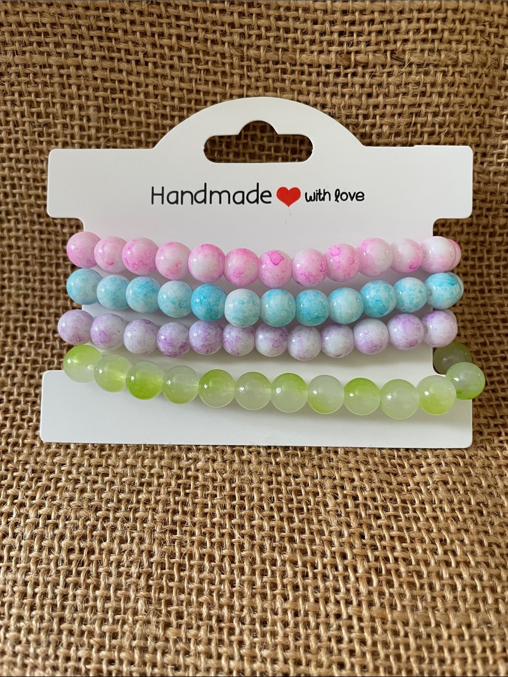 Set of Four Beaded Stretch Bracelets in Pastel Pink, Blue, Lavender, and Green
